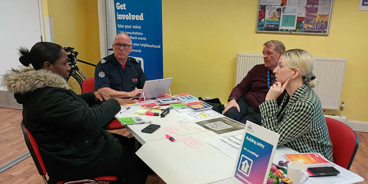 EllaMae and Dan from ISHA's Building Safety Team with Paul, Borough Commander from the London Fire Brigade talking with a resident.
