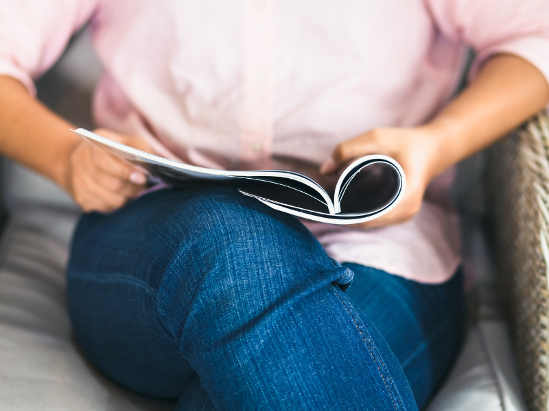 A woman reads a booklet. 