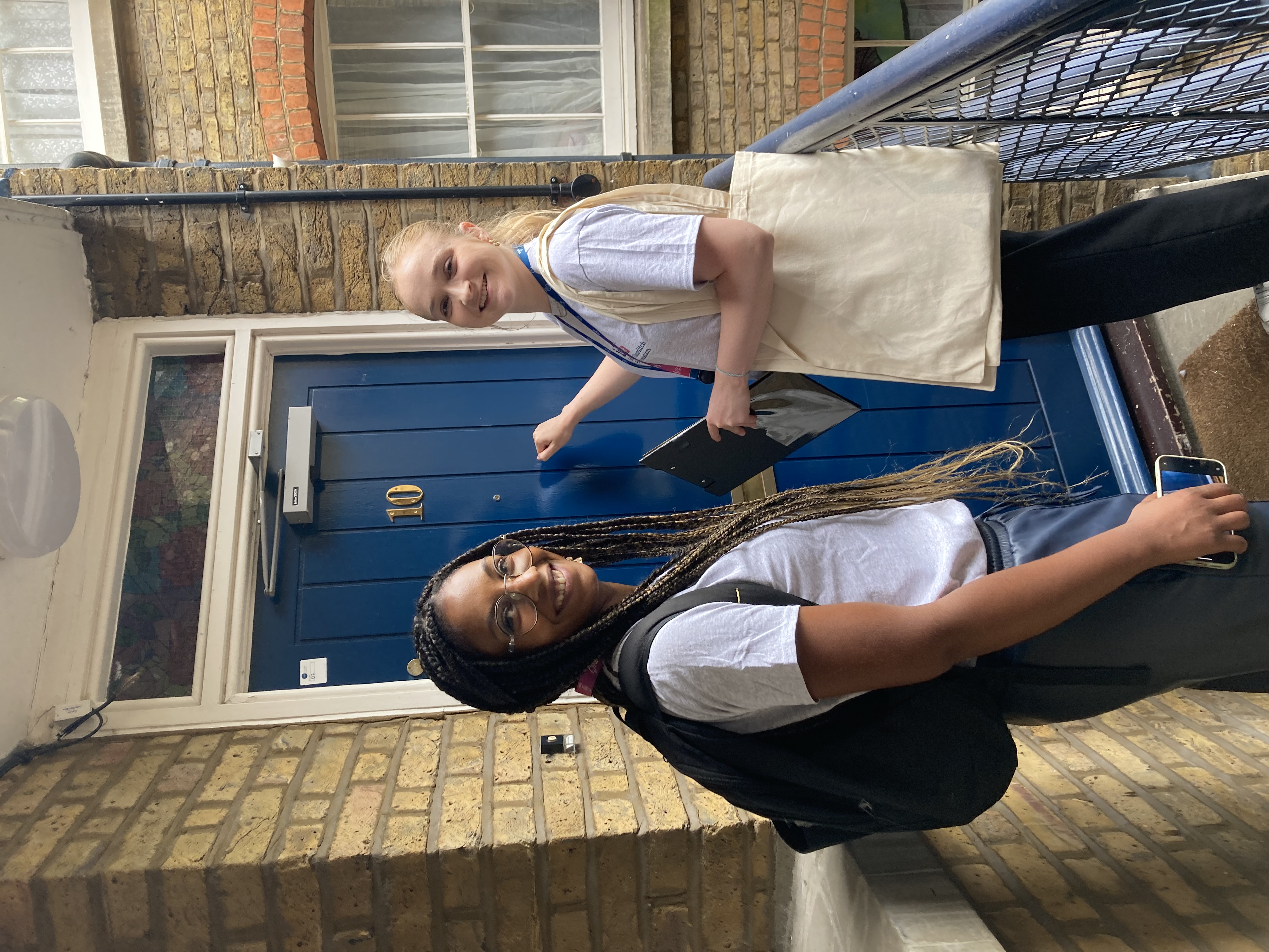 Two ISHA staff members knocking on the door of a resident.