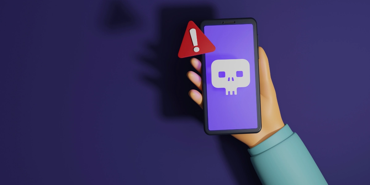 A hand holding up a mobile device with a warning symbol next to it.